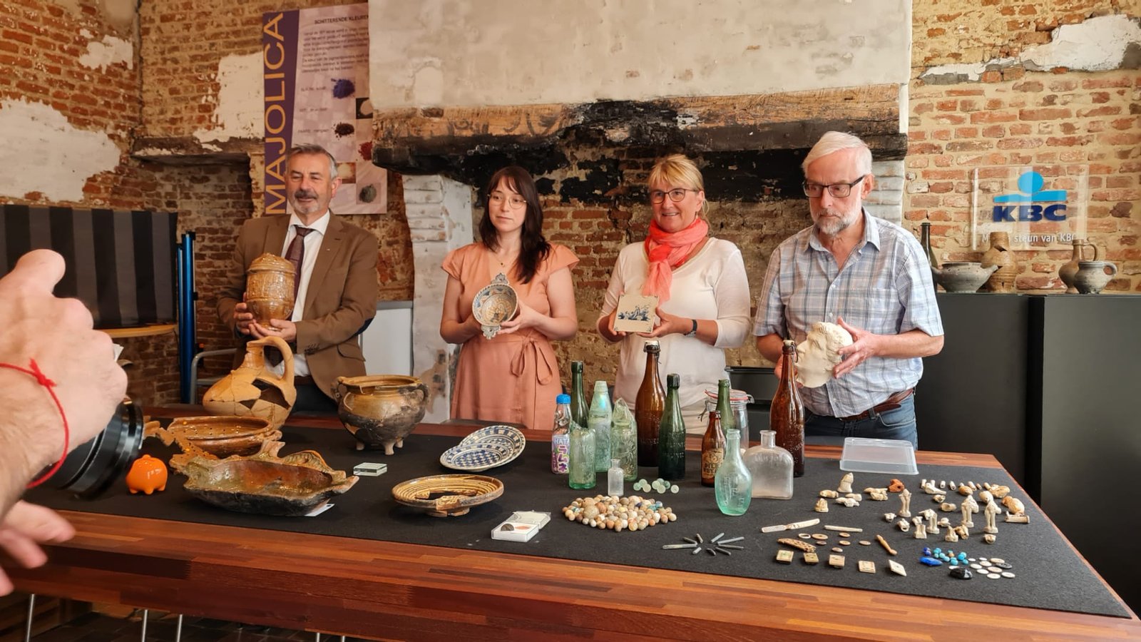 Vier leden van de MVSA tonen archeologische vondsten in het Bouw-Archeologisch Centrum
